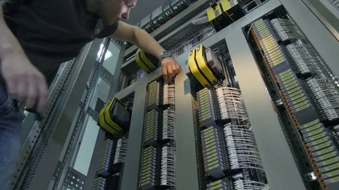 Bottom View Young Technician Twists Screws at Switchboard Stock Footage 79433141