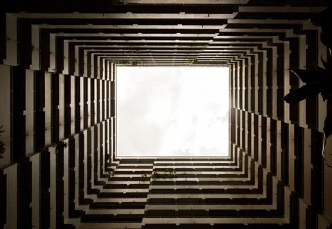 Bottoms up view of the cascading rectangular corridors balcony opening up of Stock Photos