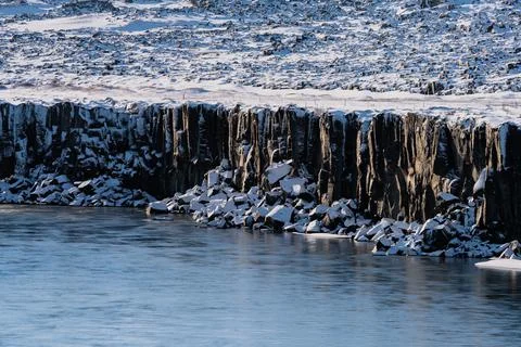 Boulder cubes under the cliffs with snow Stock Photos