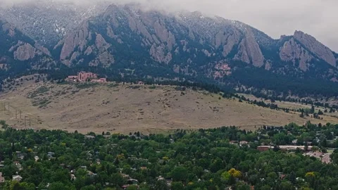 Boulder Foothills and Flatirons with Snow Patches Above Neighborhood Aerial Stock Footage 339845005