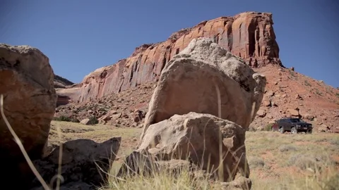 A boulder in front of rocky cliffs Indian Creek Utah Stock Footage 90961663