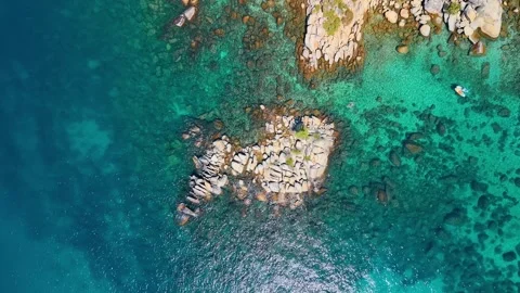 Boulder islet surrounded by turquoise Lake Tahoe water. An overhead view shows Stock Footage 346532700