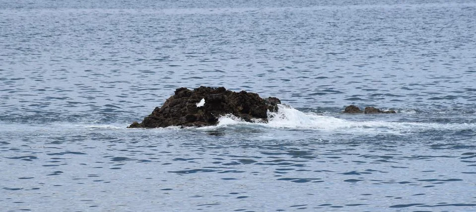 Boulder in the ocean Stock Photos