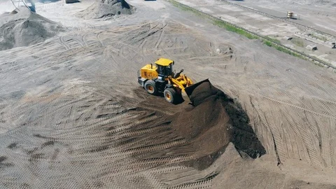 Boulder quarry with an excavator transporting ground stones Stock Footage 114305236