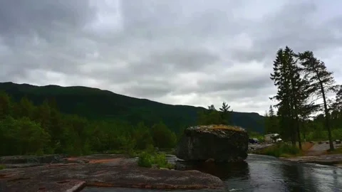 Boulder by the river in Norway with mountains in the background during clou.. Stock Footage 340201670