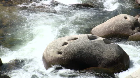 Boulder in river rapids causing white water Stock Footage 49054065