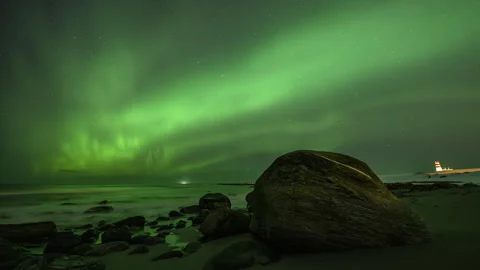 Boulder on the seashore with the Northern Lights Stock Footage 251342239