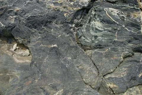 Boulder surface texture in shades of grey, brown and white - top view. Stock Photos