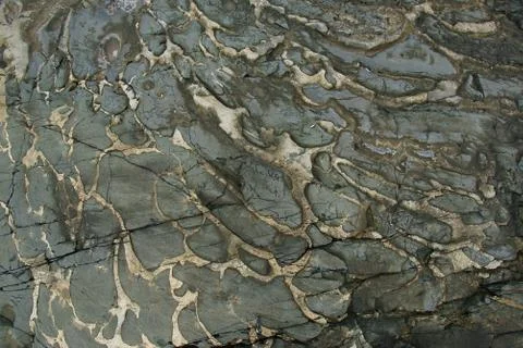 Boulder surface texture in shades of grey and yellow - top view. Stock Photos