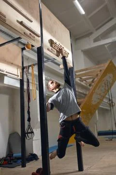 Boulderer with physical disability training at special equipment, improving grip Stock Photos