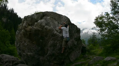 Bouldering in alpine meadow Chamonix Stock Footage 53575801