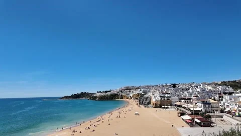 Boulevard of Albufeira Old Town with White Buildings, Blue Sea and Sky Stock Footage 334743554