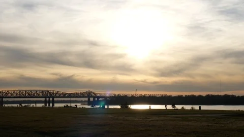 Boulevard by river against arch bridge at sunset Stock Footage 88897626