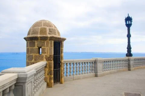 Boulevard with small tower, black lantern and sea view Stock Photos