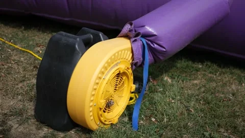 A Bounce House Inflatable Blower Device on Grass Stock Footage 317522962
