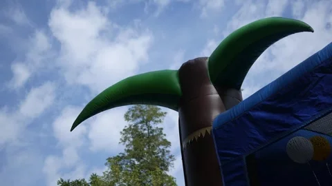 A Bounce House Set Up in Childrens Backyard for Birthday Party 2 Stock Footage 317522977