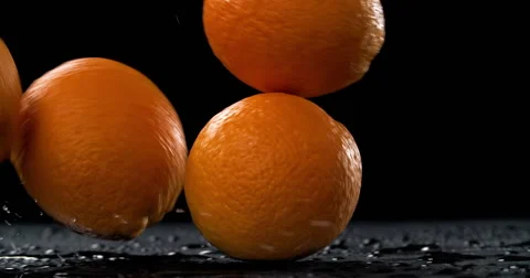 Bouncing and rolling oranges on dark background Video stock 55879588