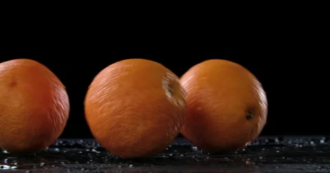 Bouncing and rolling oranges on dark background Stock Footage 58302447