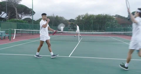 Bouncing ball then serving sharply male volleying on outdoor tennis court, with Видео 337159514