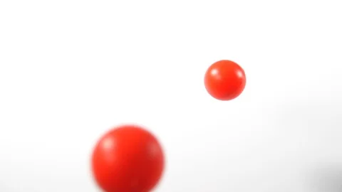 Bouncing balls popping and rolling onto around on a white background, red pink Stock Footage 90769022