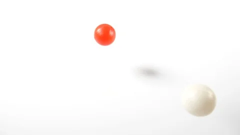 Bouncing balls popping and rolling onto around on a white background, red pink Stock Footage 90769221