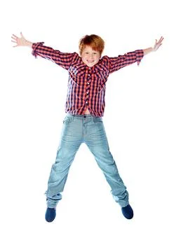 Bouncing boys. Studio shot of a young boy jumping for joy against a white Stock Photos