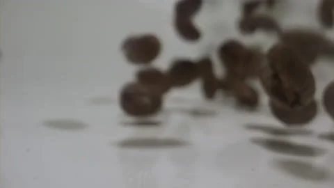 Bouncing coffee beans in extreme slow motion macro Stock Footage 144704153