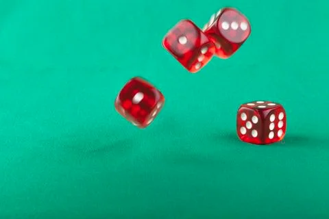 Bouncing dice on green Stock Photos