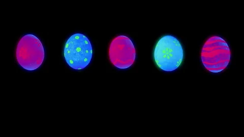 Bouncing Glowing Easter Eggs lit by Ultraviolet Light 5 Pack Stock Footage 303523060