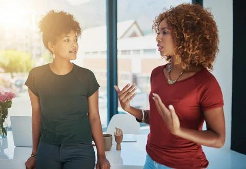 Bouncing ideas off of each other. two businesswomen chatting in an office. Stock Photos