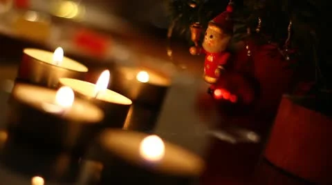 Bouncing small figure of Santa on Christmas tree under candles. Stock Footage 12140115
