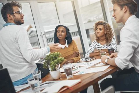 Bouncing valuable ideas off each other. a group of businesspeople having a Stock Photos