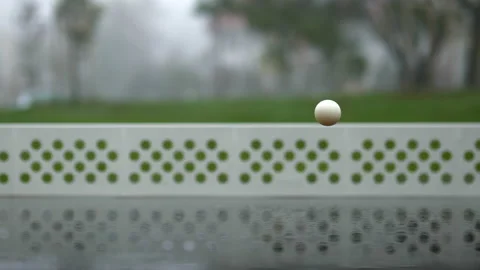 Bouncing white ball on wet ping pong table in foggy morning Stock Footage 221175481
