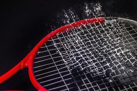 Bouncing white powder on a red racket 스톡 사진