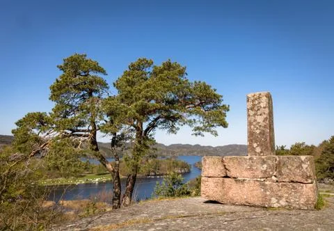Boundary stone and pine tree, with Farrisvannet, The Farris Lake, in the Stock Photos