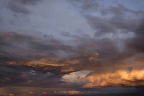 Boundless expanse of the sky with cumulus clouds and rays of the sun, moments Stock Photos