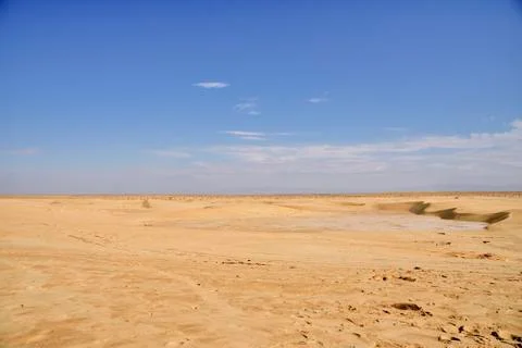 Boundless expanses of the Sahara desert, a plot of solanchak against the Stock Photos