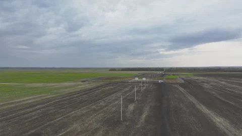 Boundless field with station and power transmission lines Stock Footage 266140175