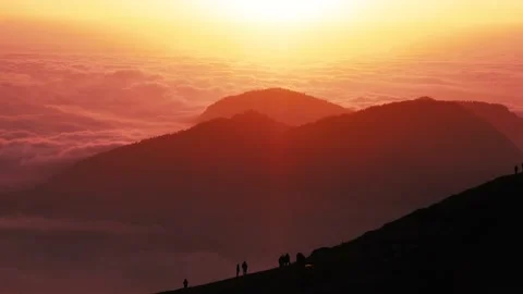 Boundless high mountains with dense mist clouds at sunset Video stock 150936809