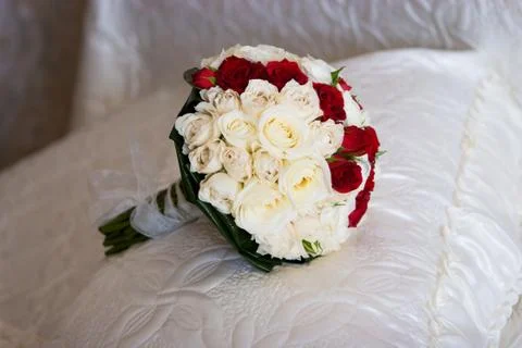 Bouquet of the bride on the bed Stock Photos