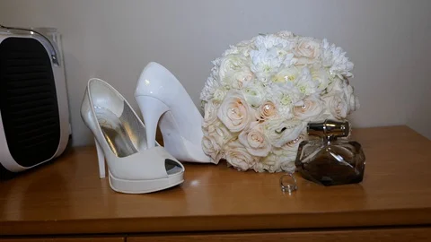 Bouquet of the bride with the wedding ring and shoe Stock Footage 129706795