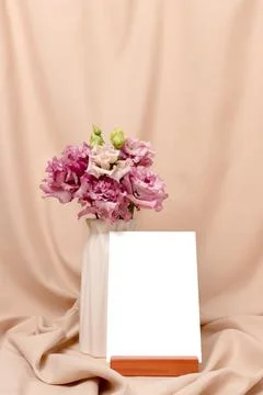 Bouquet of eustoma flowers and empty paper card mockup with copyspace. Stock Photos