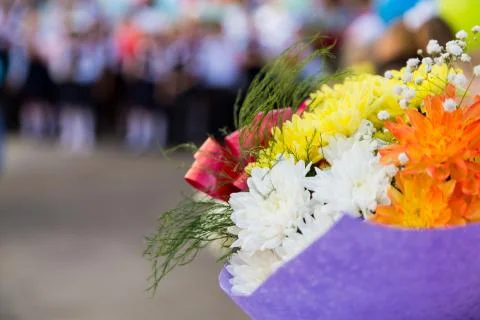 A bouquet of flowers in the hands of elementary school students Stock Photos