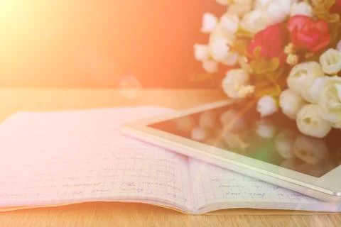 A bouquet of flowers with a PC tablet on the table. Happy Teacher's Day. Clas Stock Photos