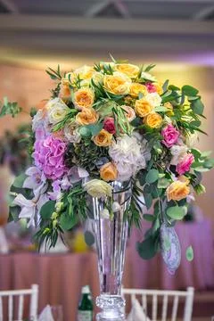Bouquet of flowers in vase on the wedding table Stock Photos