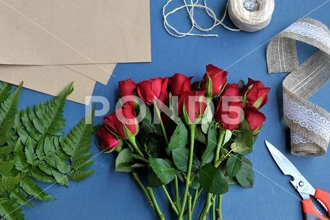 Bouquet of fresh red roses over the blue background Stock Photos