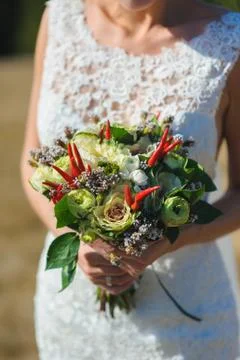Bouquet in hands of bride Stock Photos