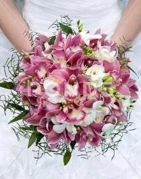 Bouquet Of Orchids, Roses And Other Flowers In The Bride's Hands Closeup.