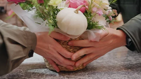 Bouquet presentation scene. Vendor carefully presents crafted bouquet featuring Stock Footage 330037342