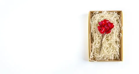 Bouquet of red hearts in a rectangular box with paper filling, top view Stock Photos